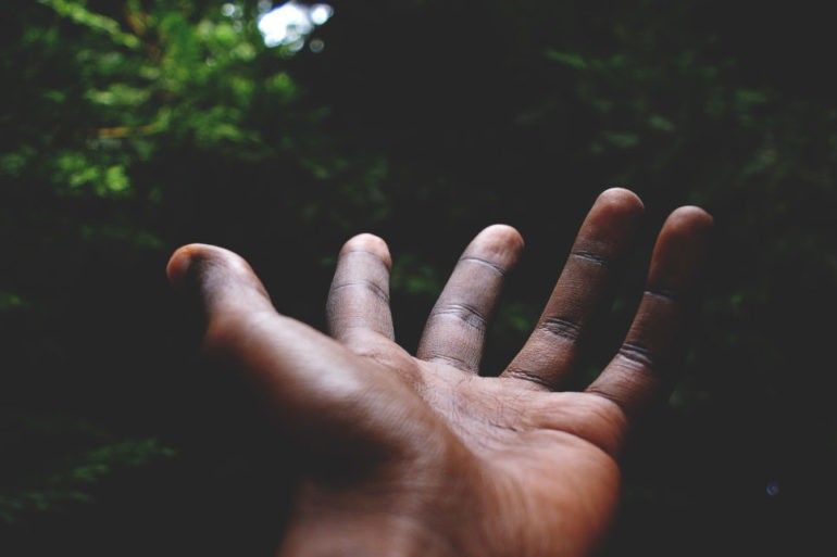 Black man's hands in the forest