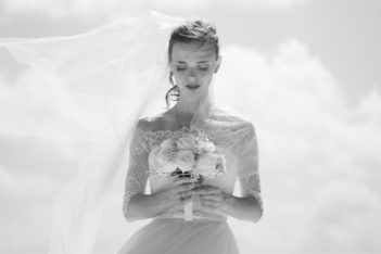 grayscale picture of bride holding flower bouquet