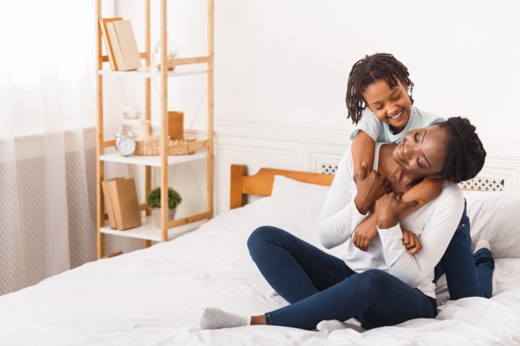 Full length image of black family in bedroom